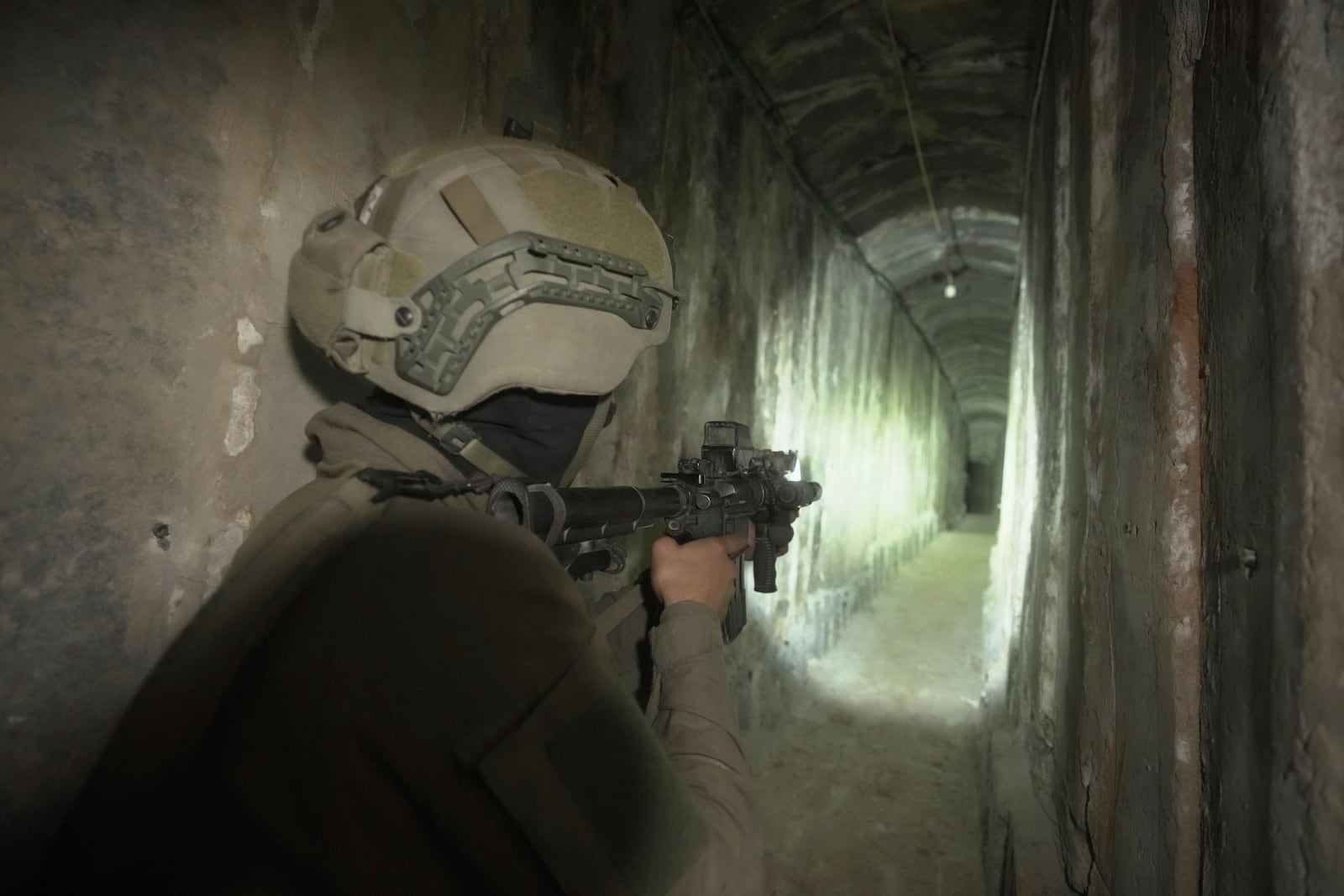 FILE - Israeli soldier shows the media an underground tunnel found underneath Shifa Hospital in Gaza City, Nov. 22, 2023. (AP Photo/Victor R. Caivano, File)