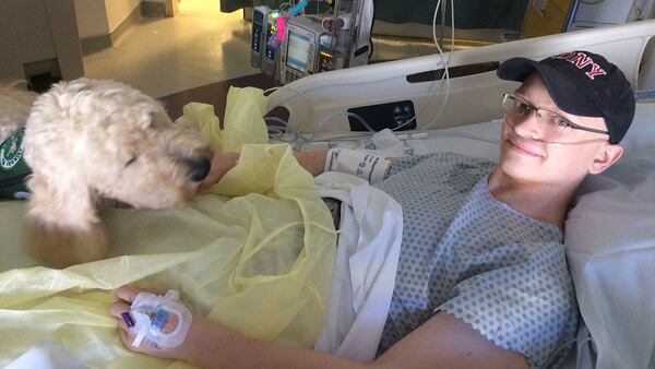 Michael Torpy with service dog in the hospital. Torpy family photo