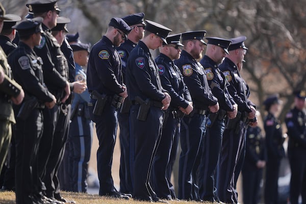 Officers wait for slain West York Borough Police Officer Andrew Duarte's funeral procession from Living Word Community Church, in Red Lion, Pa., Friday, Feb. 28, 2025. (AP Photo/Matt Rourke)