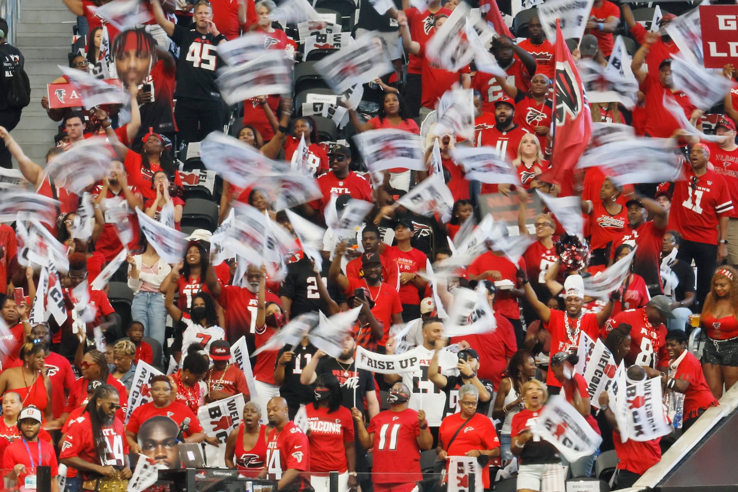 Atlanta Falcons fans waves flags as they cheer at the beginning of the first half of an NFL exhibition game against the Jacksonville, Jaguars on Saturday, August 27, 2022, at the Mercedes-Benz Stadium in Atlanta, Ga.
 Miguel Martinez / miguel.martinezjimenez@ajc.com