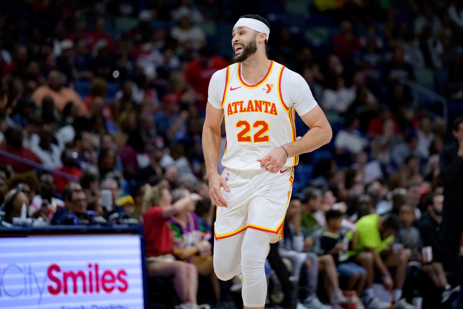 Atlanta Hawks forward Larry Nance Jr. (22) smiles after making a 3-point basket against his former team, the New Orleans Pelicans, during the first half of an NBA basketball game in New Orleans, Sunday, Nov. 3, 2024. (AP Photo/Matthew Hinton)