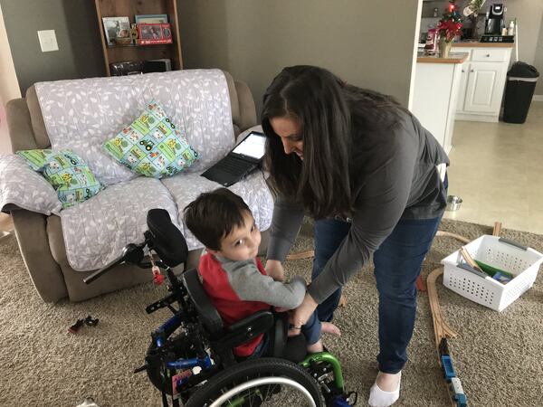 Jennifer Peteet and her son, Reid, at home in Winder. Reid was diagnosed with AFM and now uses a wheelchair. SHELIA POOLE / SPOOLE@AJC.COM