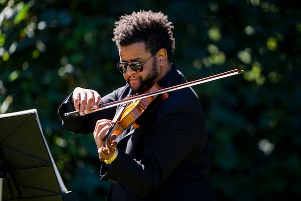 Christopher Mosley plays the violin during the dedication of a historical marker for Zeb Long, a lynching victim from the 1906 Atlanta Race Massacre, on Saturday, September 24, 2022, at Sumner Park in East Point. CHRISTINA MATACOTTA FOR THE ATLANTA JOURNAL-CONSTITUTION