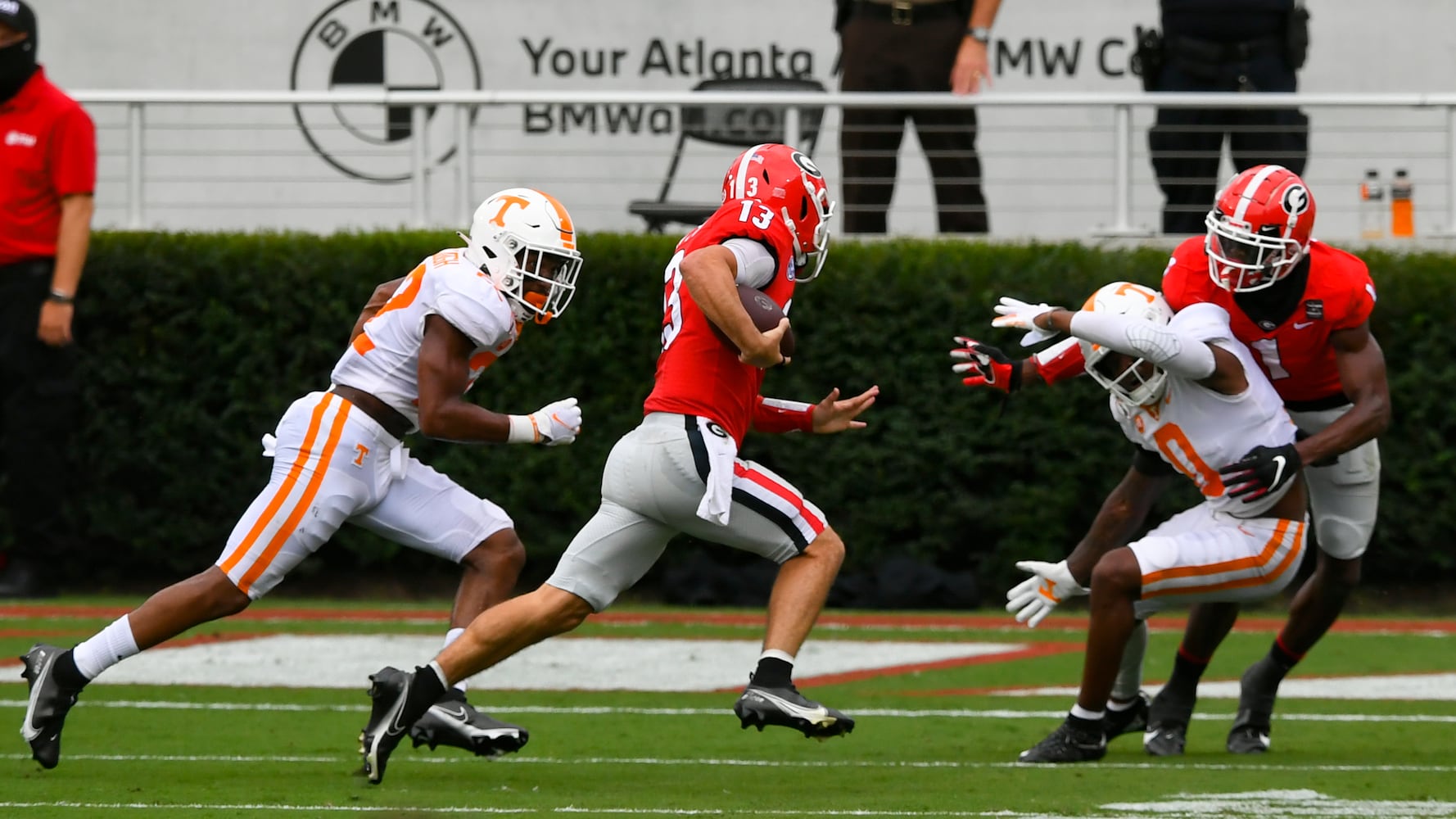 Georgia quarterback Stetson Bennett (13) runs for a td as Tennessee defensive back Jaylen McCollough, left, chases and Tennessee defensive back Bryce Thompson (0) is blocked by Georgia wide receiver George Pickens, right, during the first half of a football game Saturday, Oct. 10, 2020, at Sanford Stadium in Athens. JOHN AMIS FOR THE ATLANTA JOURNAL- CONSTITUTION