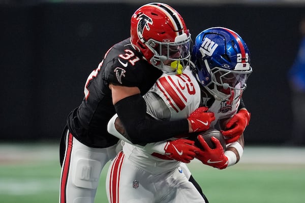 Atlanta Falcons safety Justin Simmons (31) tackles New York Giants running back Tyrone Tracy Jr. (29) in the first half of an NFL football game in Atlanta, Sunday, Dec. 22, 2024. (AP Photo/Mike Stewart)