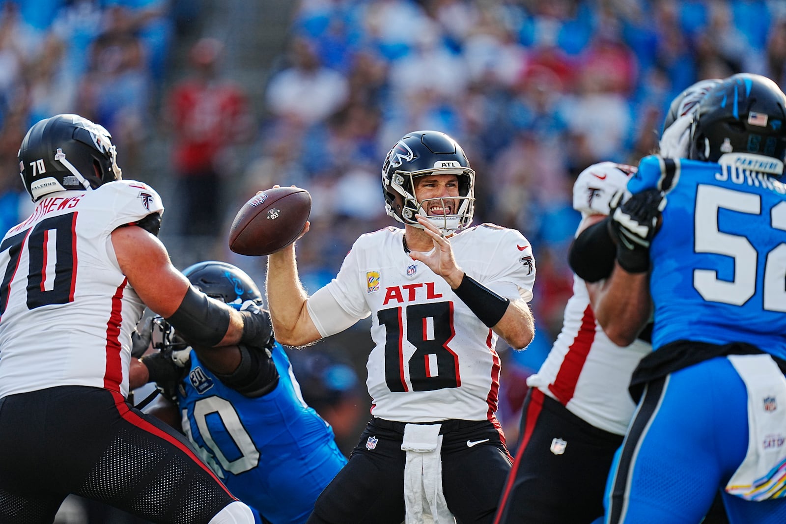 Atlanta Falcons quarterback Kirk Cousins (18) looks to pass in the first half of an NFL football game against the Carolina Panthers in Charlotte, N.C., Sunday, Oct. 13, 2024. (AP Photo/Rusty Jones)