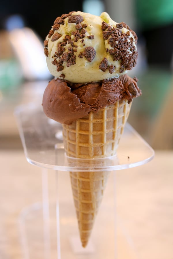 A double scoop of Honeysuckle Gelato: dark chocolate gelato topped with fresh mint gelato and sprinkled with chocolate chips.