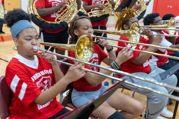 Nyla Palmer (left) practices with the JHS Majestic Marching Cardinals at Jonesboro High School.  (Steve Schaefer/steve.schaefer@ajc.com)