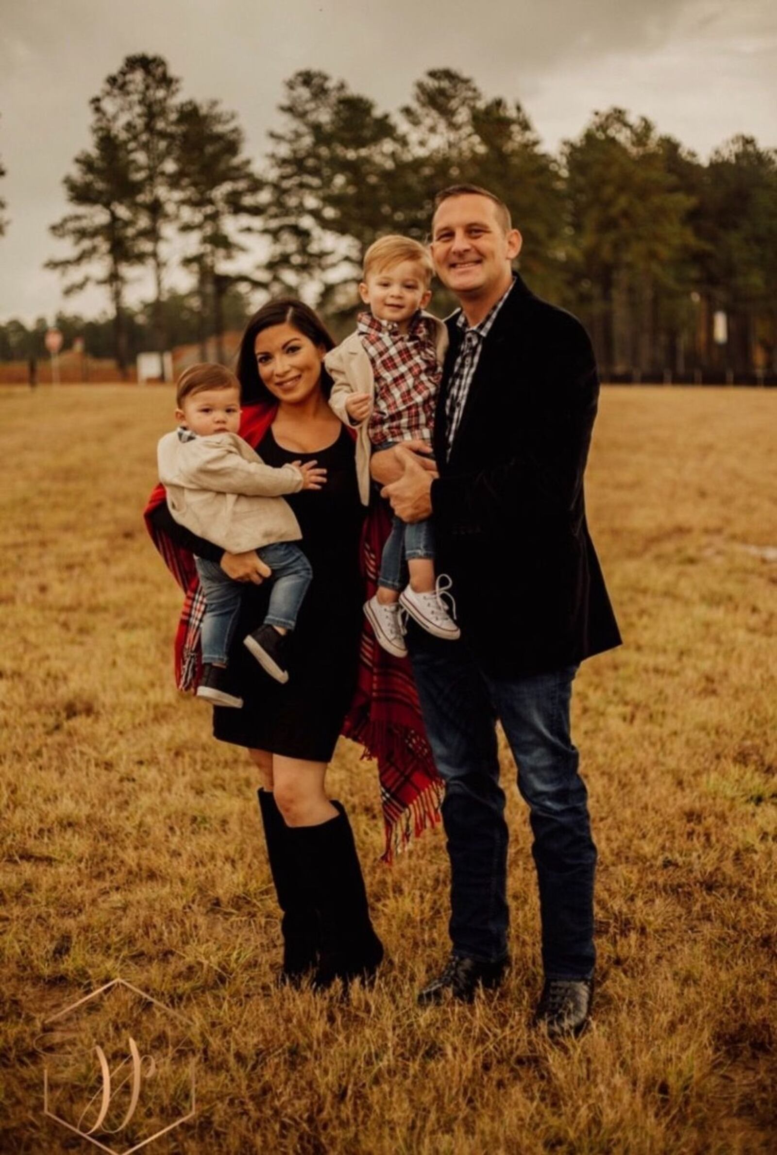 Devon and Jill Phelps pose with their sons, ages 2 and 4. The couple was struck by a vehicle while jogging along the Chattahoochee River in Roswell. (Courtesy of the Phelps family)