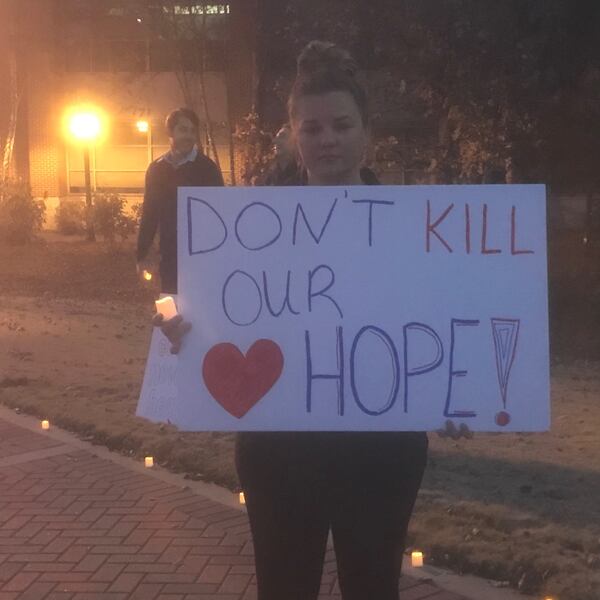 University of West Georgia doctoral student Lori Jordan Fountain was one of more than a dozen students who participated in a candlelight vigil on its Carrollton campus to protest against possible faculty cuts. ERIC STIRGUS / ESTIRGUS@AJC.COM.