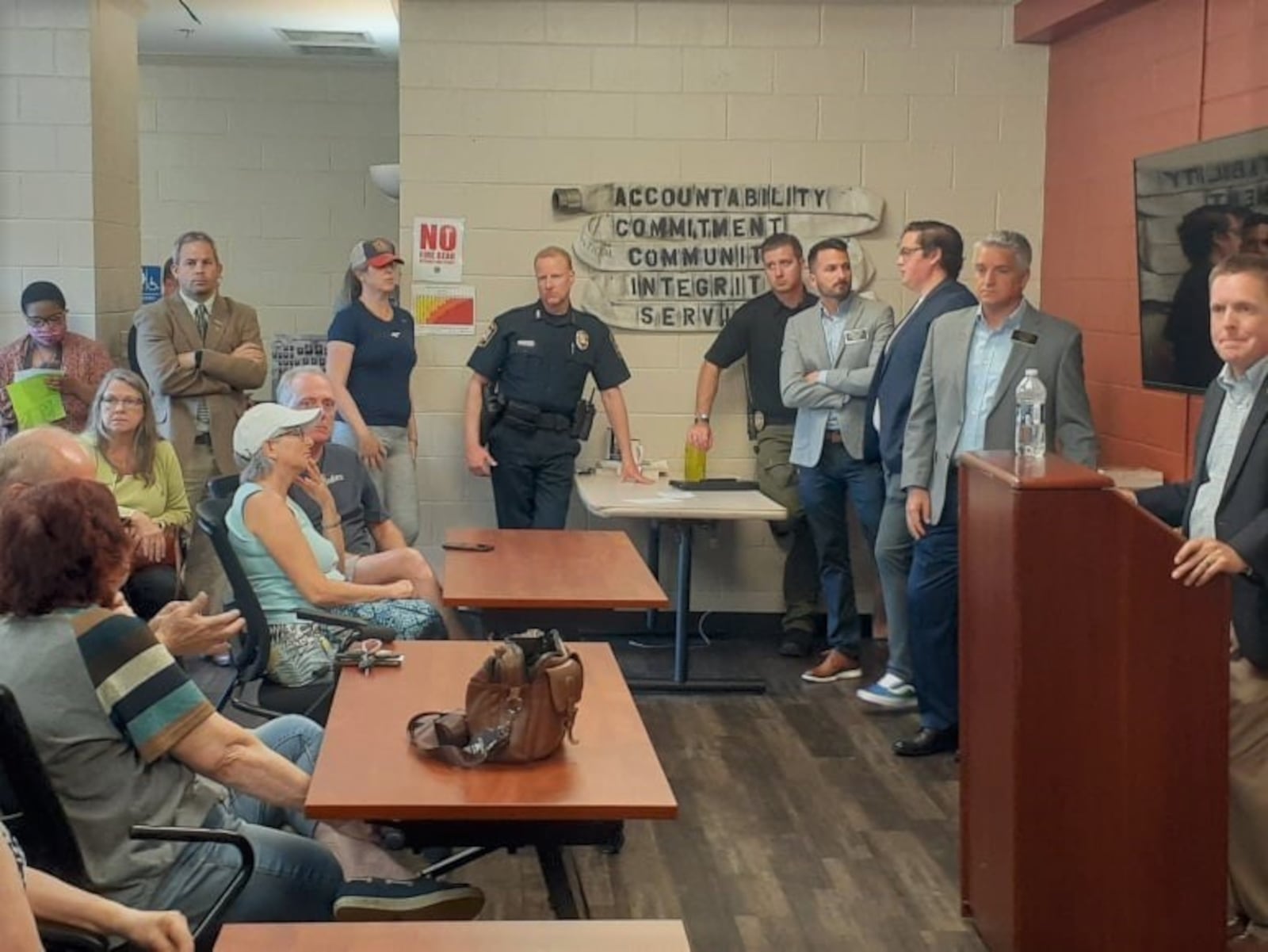 Smyrna Mayor Derek Norton, far right, answers questions from residents during a town hall meeting Wednesday night. Many residents were critics of the city's downtown redevelopment plan and badgered city officials about plans to sell property to a Suwanee brewery. (Photo by Matt Bruce for the AJC)