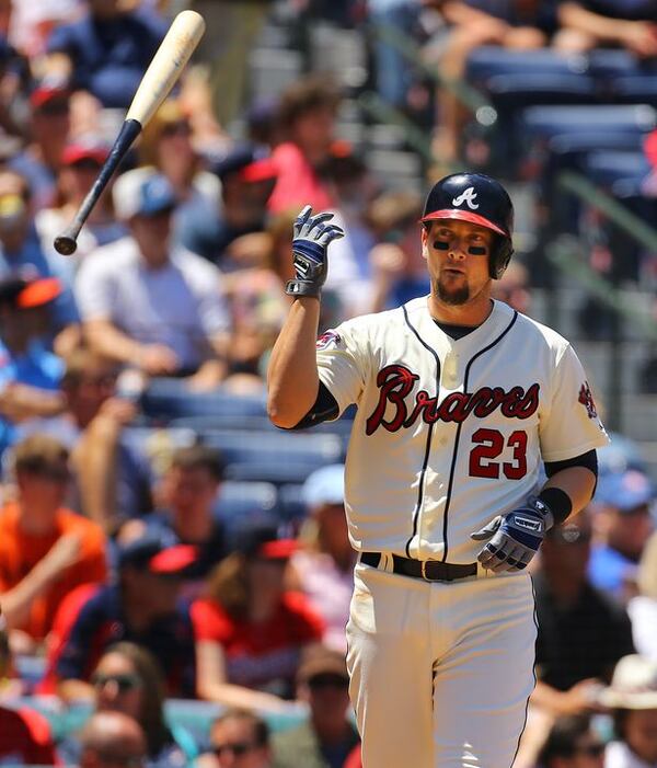 Chris Johnson displays the proper method of bat disposal. (Curtis Compton/AJC)