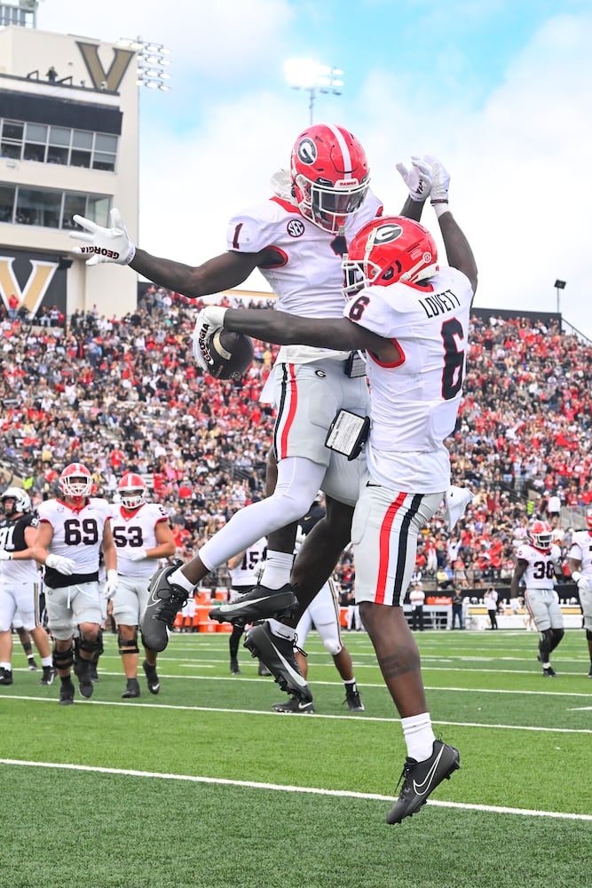 Georgia wide receiver Dominic Lovett (6) and wide receiver Marcus Rosemy-Jacksaint (1) celebrate a touchdown catch by Lovett against Vanderbilt during the second half of an NCAA football game, Saturday, Oct. 14, 2023, in Nashville, Tenn. (Special to the AJC/John Amis)