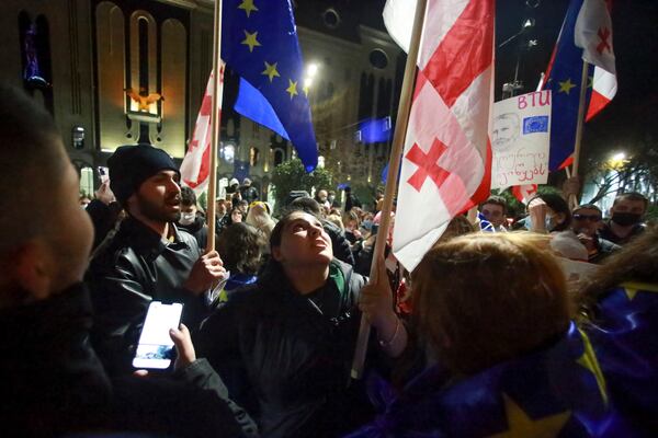 Protesters pour into the streets following the country's ruling party suspended negotiations to join the European Union until 2028, rallying outside the parliament building in Tbilisi, Georgia, Friday, Nov. 29, 2024. (AP Photo/Zurab Tsertsvadze)