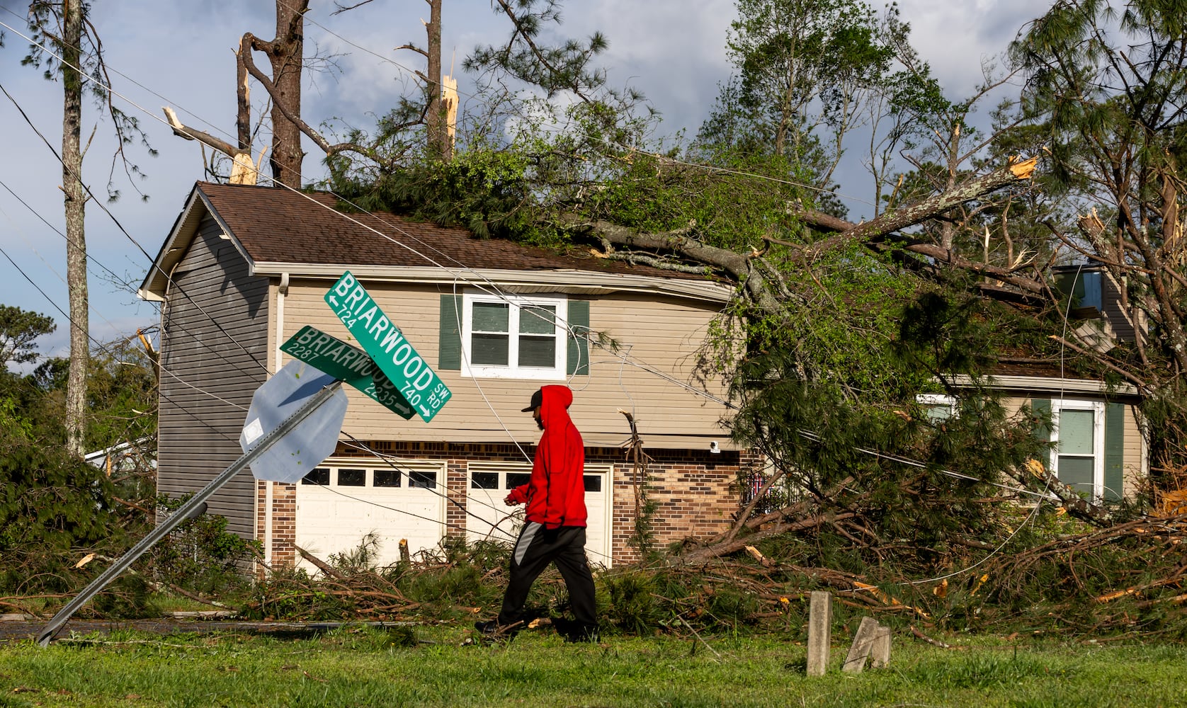 Monta Lemons on Briarwood Road surveys the damage after a night of turbulent storms. Cleanup efforts were underway Wednesday, April 3, 2024, in Rockdale County, where at least one tornado was reported to have touched down and left a path of destruction. (John Spink / John.Spink@ajc.com)