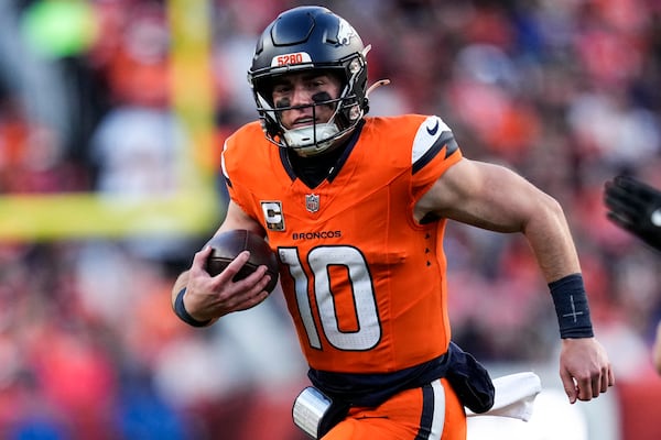 Denver Broncos quarterback Bo Nix (10) runs out of the pocket against the Atlanta Falcons during the second half of an NFL football game, Sunday, Nov. 17, 2024, in Denver. (AP Photo/Jack Dempsey)