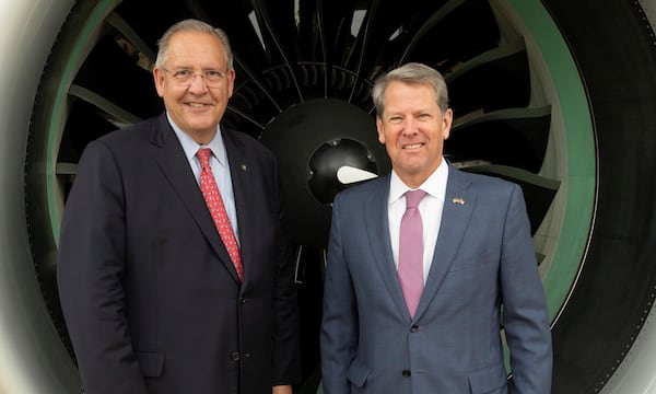 Gregory J. Hayes (left), the chairman and chief executive officer of Raytheon Technologies, and Gov. Brian Kemp posed in front of a Pratt & Whitney GTF engine displayed at the entrance of the RTX pavilion at the Paris Air Show 2023, Le Bourget Airport, Paris, France, on June 20, 2023. (Alex MacNaughton for Raytheon Technologies)