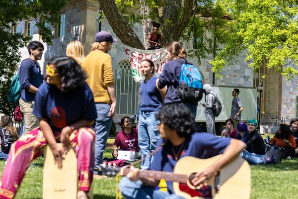 Students sing songs in the quad after a rally protesting Atlanta’s proposed public safety training center at Emory University in Atlanta on Monday, April 24, 2023. (Arvin Temkar / arvin.temkar@ajc.com)