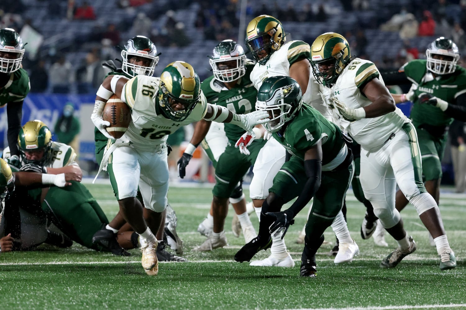 Dec. 30, 2020 - Atlanta, Ga: Grayson running back Jayvian Allen (16) scores a rushing touchdown against Collins Hill defensive back Justin Richardson (4) in the first half during the Class 7A state high school football final at Center Parc Stadium Wednesday, December 30, 2020 in Atlanta. JASON GETZ FOR THE ATLANTA JOURNAL-CONSTITUTION