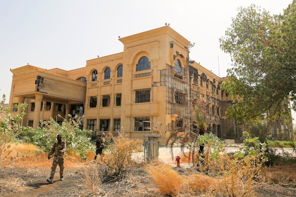 Army soldiers walk in front of the damaged Republican Palace in Khartoum, Sudan, after it was taken over by Sudan's army Friday, March 21, 2025. (AP Photo)