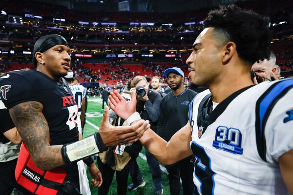 Falcons quarterback Michael Penix Jr. (left) and Panthers quarterback Bryce Young after Atlanta's season-ending overtime loss. 