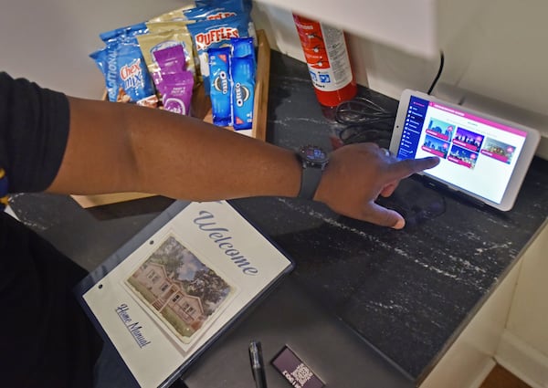 April 11, 2019 Atlanta - Justin Heard shows off high tech amenities, including digital kiosk, as his wife Charalaina Heard looks on at their Airbnb home in the Edgewood neighborhood. HYOSUB SHIN / HSHIN@AJC.COM