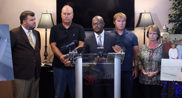 Attorney Cade Parian (from left) Kevin Sherman, Attorney L. Chris Stewart, David Sherman, and Mary Ann Sherman talk to the media on Wednesday in Atlanta. The family of Chase Sherman, who was killed during a bizarre altercation with Coweta County deputies and an EMT, spoke out today in reaction to the DA’s decision not to bring charges against the deputies. David Sherman, the victim’s brother, and his parents, Kevin and Mary Ann Sherman, talked to reporters along with attorneys L. Chris Stewart and Cade Parian. BOB ANDRES /BANDRES@AJC.COM