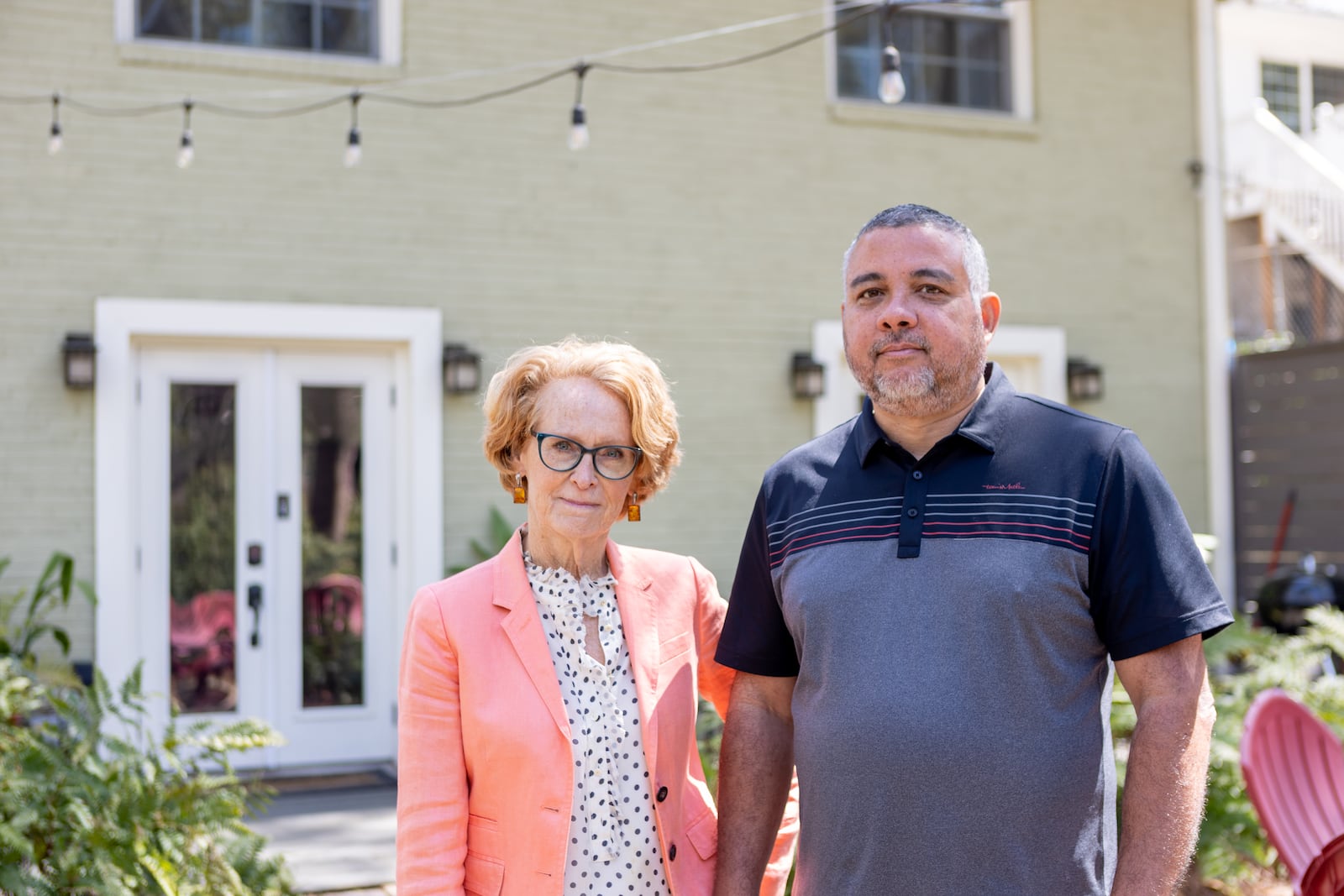 Rich Munroe and Kathie McClure, president and vice president of the Atlanta Short Term Rental Association, pose for a photo in front of a rental home owned by McClure in Atlanta, GA., on Friday, April 1, 2022. (Photo/Jenn Finch)