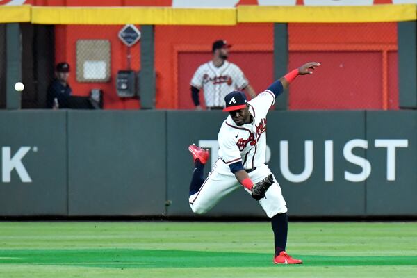 A ball hit by Los Angeles Dodgers center fielder Chris Taylor falls gets by Braves center fielder Guillermo Heredia, scoring two runs, during the seventh inning of Game 2 of the NLCS Sunday, Oct. 17, 2021, at Truist Park in Atlanta. (Hyosub Shin / Hyosub.Shin@ajc.com)