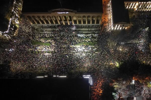 Demonstrators rally outside the parliament's building, top, to protest the government's decision to suspend negotiations on joining the European Union for four years in Tbilisi, Georgia, on Friday, Nov. 29, 2024. (AP Photo/Zurab Tsertsvadze)