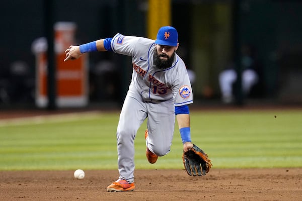 New York Mets third baseman Luis Guillorme fields a grounder hit by Arizona Diamondbacks' Gabriel Moreno, who was out at first during the eighth inning of a baseball game Thursday, July 6, 2023, in Phoenix. The Mets won 9-0. (AP Photo/Ross D. Franklin)