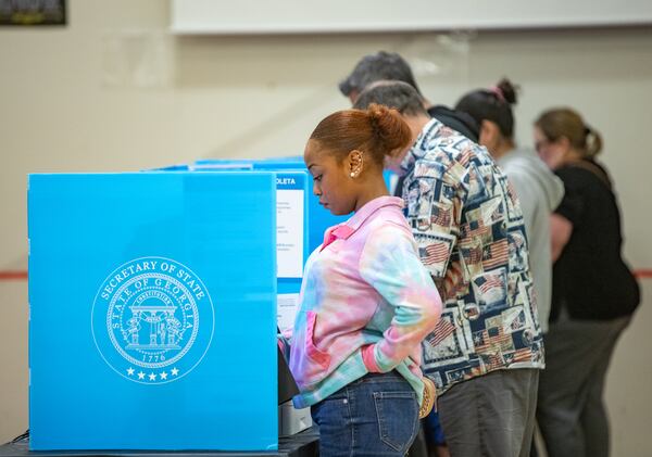 Gwinnett County voters, including Khameelah Hasan, cast their ballots on Election Day at in Loganville.