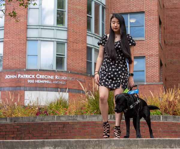 Legally blind Georgia Tech student, Nola Timmins, walks around the campus with the help of her guide dog and best friend, Brizzy. PHIL SKINNER FOR THE ATLANTA JOURNAL-CONSTITUTION.