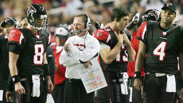 Falcons coach Bobby Petrino confers with quarterback Chris Redman (8) on the sidelines between plays as Joey Harrington (13) and Byron Leftwich (4) standby during fourth quarter Monday, Dec. 10, 2007, at the Georgia Dome in Atlanta. It was Petrino's last game as Falcons head coach.