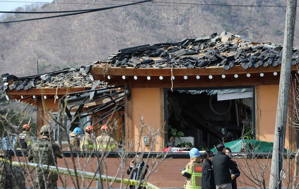 Rescue members work at a bomb accident site where a South Korean fighter jet accidentally dropped bombs on a civilian area during training, in Pocheon, South Korea, Thursday, March 6, 2025. (Yonhap via AP)