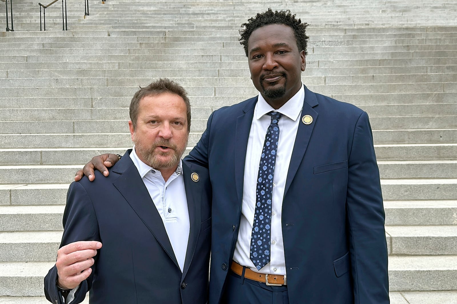 South Carolina state Reps. Brandon Cox, R-Goose Creek, left, and Jermaine Johnson, D-Columbia, right talk about their efforts to honor Robert Smalls, who will soon be the first African American individual with a statue at the South Carolina Statehouse, Friday, Sept. 13, 2024, in Columbia, S.C. (AP Photo/Jeffrey Collins)