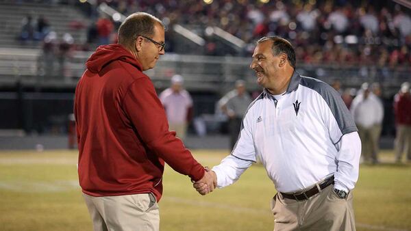 Lowndes head coach Randy McPherson (left) greets Norcross head coach Keith Maloof before the game.