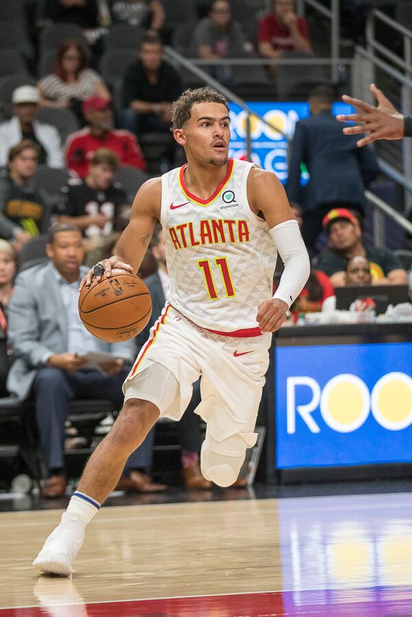 Hawks guard Trae Young (11) dribbles against the Orlando Magic. (Alyssa Pointer/Atlanta Journal Constitution)