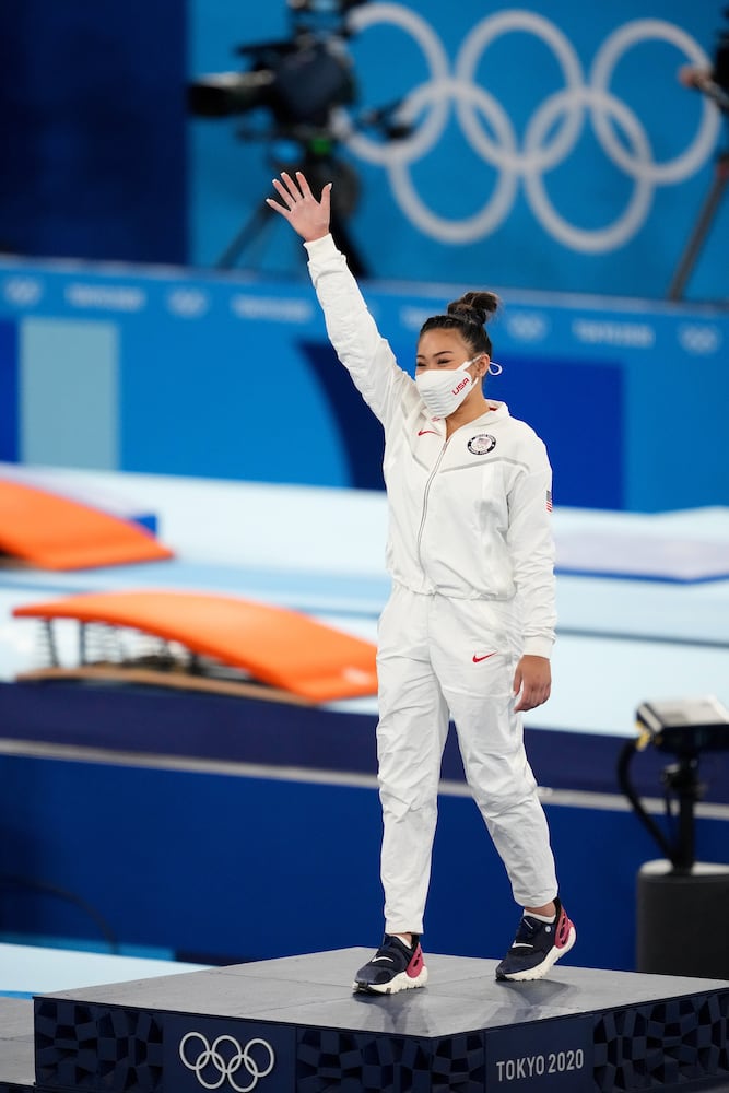 Sunisa Lee of the United States stands on the medal podium after winning gold in the women's all-around gymnastics competition at the postponed 2020 Tokyo Olympics in Tokyo on Thursday, July 29, 2021. (Chang W. Lee/The New York Times)