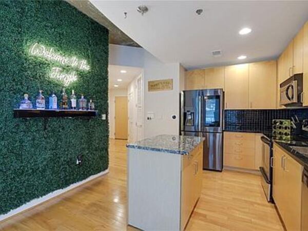 The condo kitchen has a smart fridge and movable island.