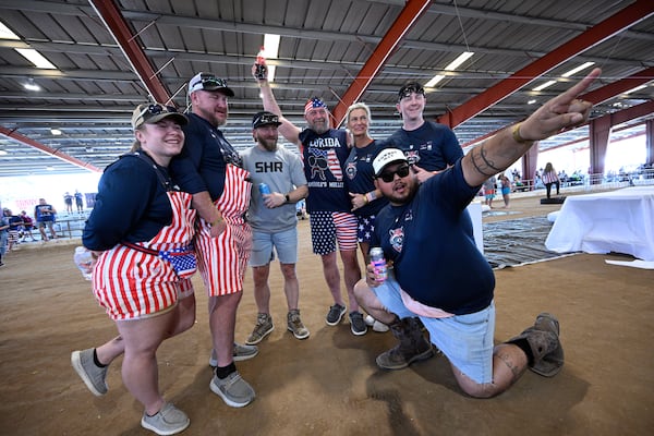 NASCAR driver Jeffrey Earnhardt, center left, poses with members of the Trash Bandits team from Destin, Fla., during the Florida Man Games, Saturday, March 1, 2025, in Elkton, Fla. (AP Photo/Phelan M. Ebenhack)