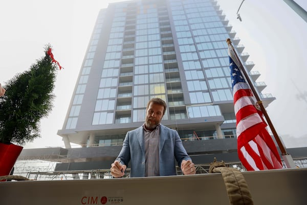 Brian McGowan, CEO of Centennial Yards, signs a piece of the roof to mark a milestone in the construction of the Phoenix Hotel, which has now reached its highest point. The boutique hotel is one of six buildings under construction at Centennial Yards in downtown Atlanta.
(Miguel Martinez / AJC)