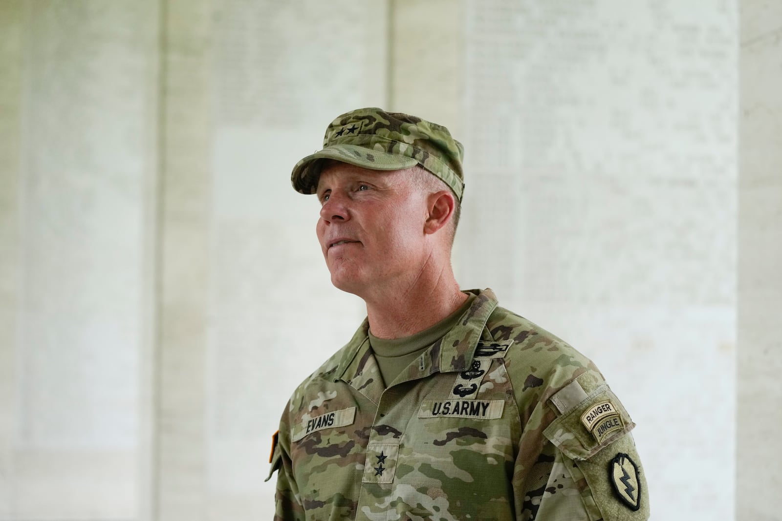 U.S. Maj. Gen. Marcus Evans, commanding general of the U.S. Army's 25th Infantry Division looks at names of American soldiers who died during World War II that are carved on a wall at the Manila American Cemetery and Memorial in Taguig, Philippines Monday, Oct. 21, 2024. (AP Photo/Aaron Favila)