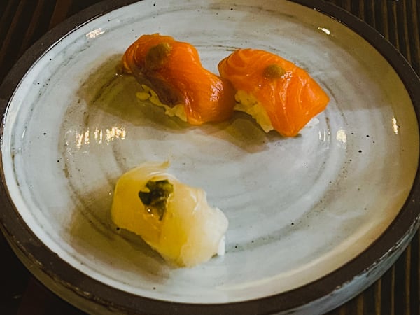 The first nigiri course in this 12-course chef set at Cuddlefish: two pieces of steelhead trout and one of hirame, or Japanese flounder. Henri Hollis/henri.hollis@ajc.com