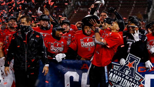 Cincinnati quarterback Desmond Ridder holds the trophy following the American Athletic Conference championship against Tulsa, Saturday, Dec. 19, 2020, in Cincinnati. Cincinnati won 27-24. (Aaron Doster/AP)