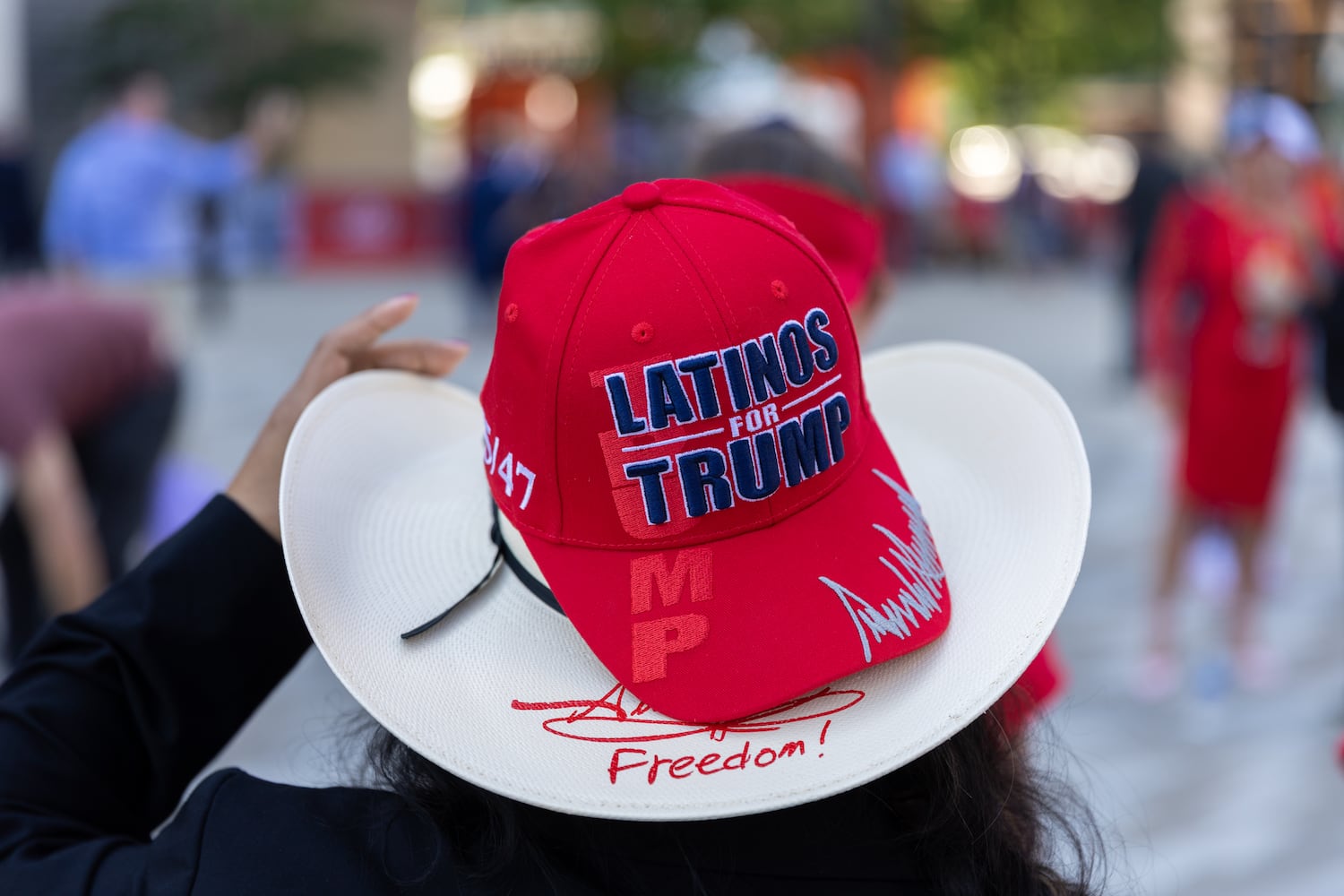 A person wears a “Latinos for Trump” hat outside Fiserv Form in Milwaukee on Thursday, July 18, 2024, the fourth day of the Republican National Convention (Arvin Temkar / AJC)