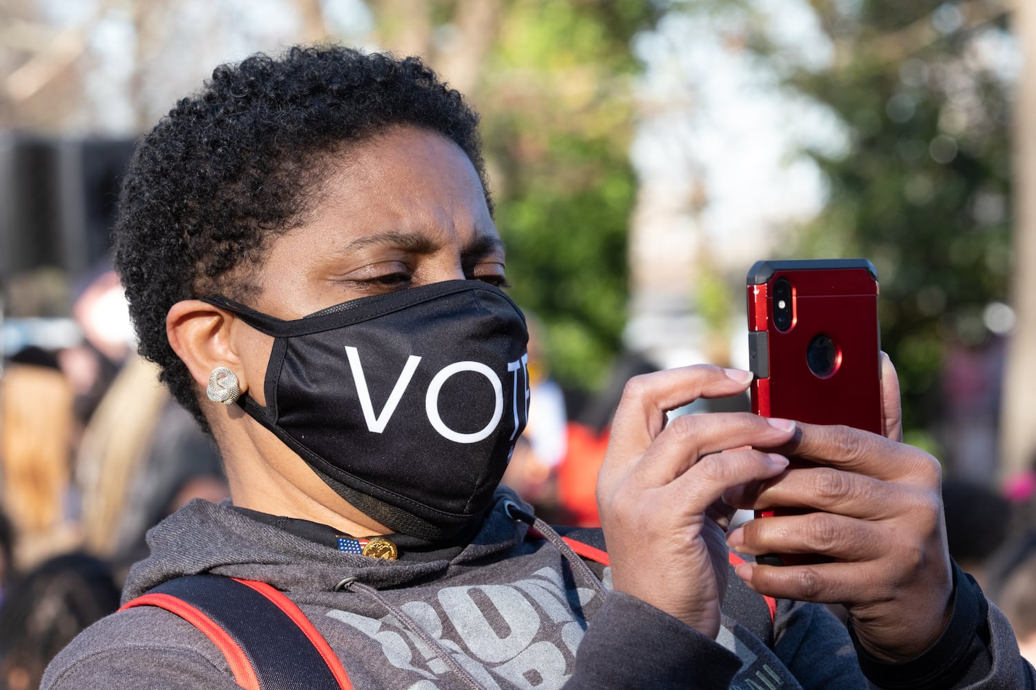 220111-Atlanta-A woman takes a photo before President Joe Biden and Vice President Kamala Harris spoke about voting rights during at Clark Atlanta University on Tuesday, Jan. 11, 2022.  Ben Gray for the Atlanta Journal-Constitution