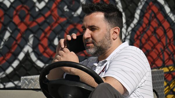 Braves general manager Alex Anthopoulos working the phones during Spring Training 2024.