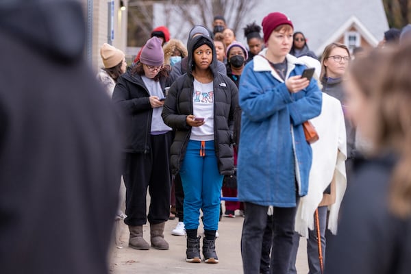 Voters wait in line at Metropolitan Library on the last day of early voting in Atlanta on Friday, December 2, 2022.   (Arvin Temkar / arvin.temkar@ajc.com)