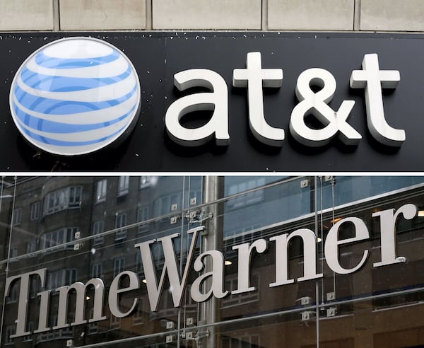 A combo file picture shows an AT&T store (top) in New York City, New York, USA, on 04 December 2008, and a view of the Time Warner Center (bottom) in New York City, New York, on Feb. 13, 2014.